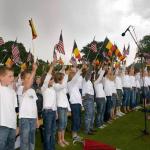Local school children sing national anthems: In a tradition dating back nearly eight decades, local school children in Waregem sing the American & Belgian national anthems each Memorial Day at Flanders Field. Local school children sing national anthems